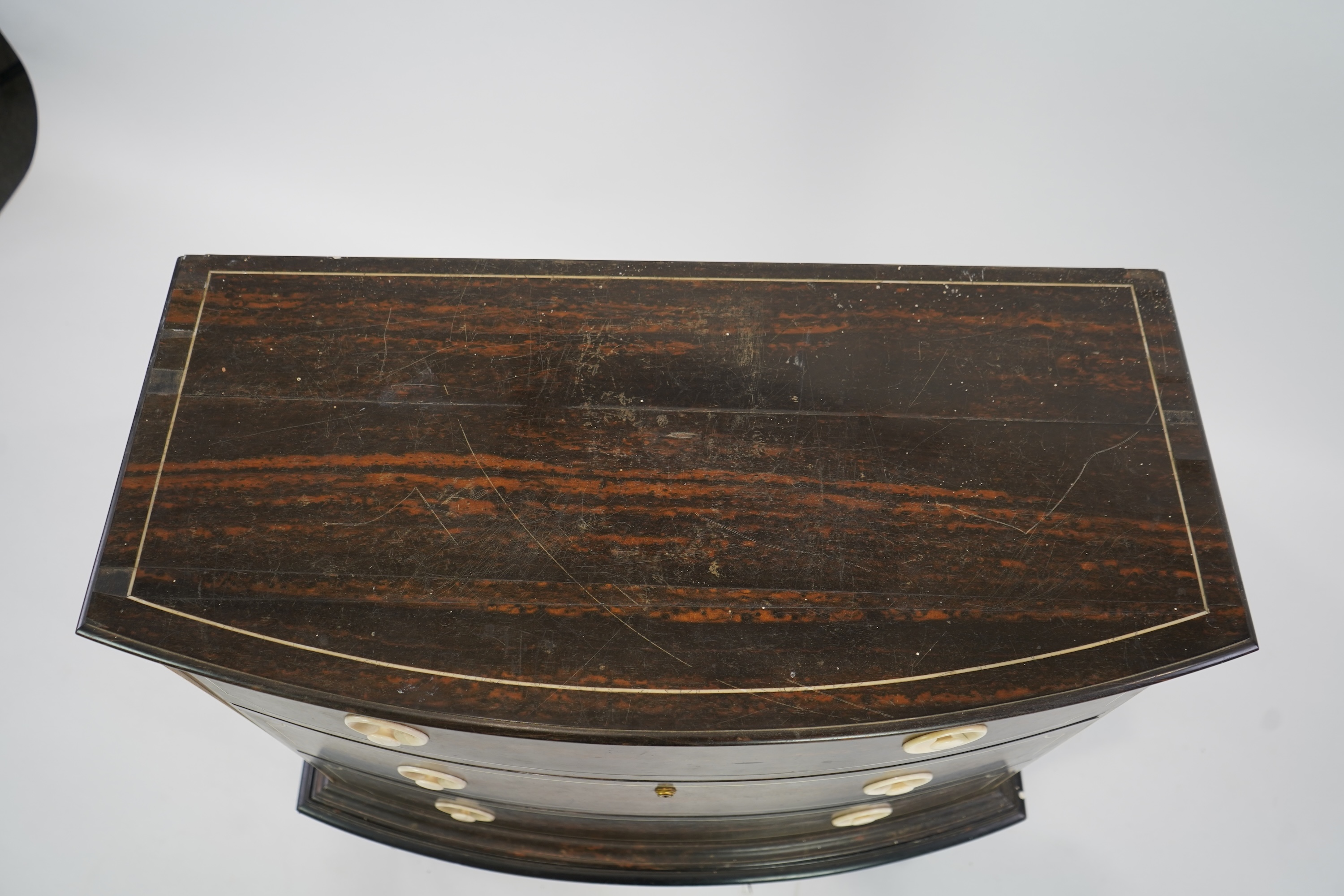 An early 20th century ivory mounted coromandel three drawer bowfront chest, stamped Callow of Mount Street, London